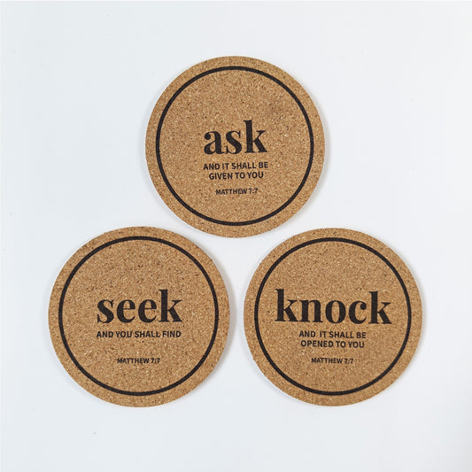 A set of 3 circle cork coasters with Bible verses Matthew 7:7 Ask Seek Knock on a white background