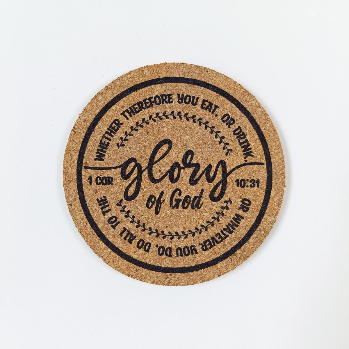 Circle cork coaster with Bible verse 1 Corinthians 10:31 on a white background