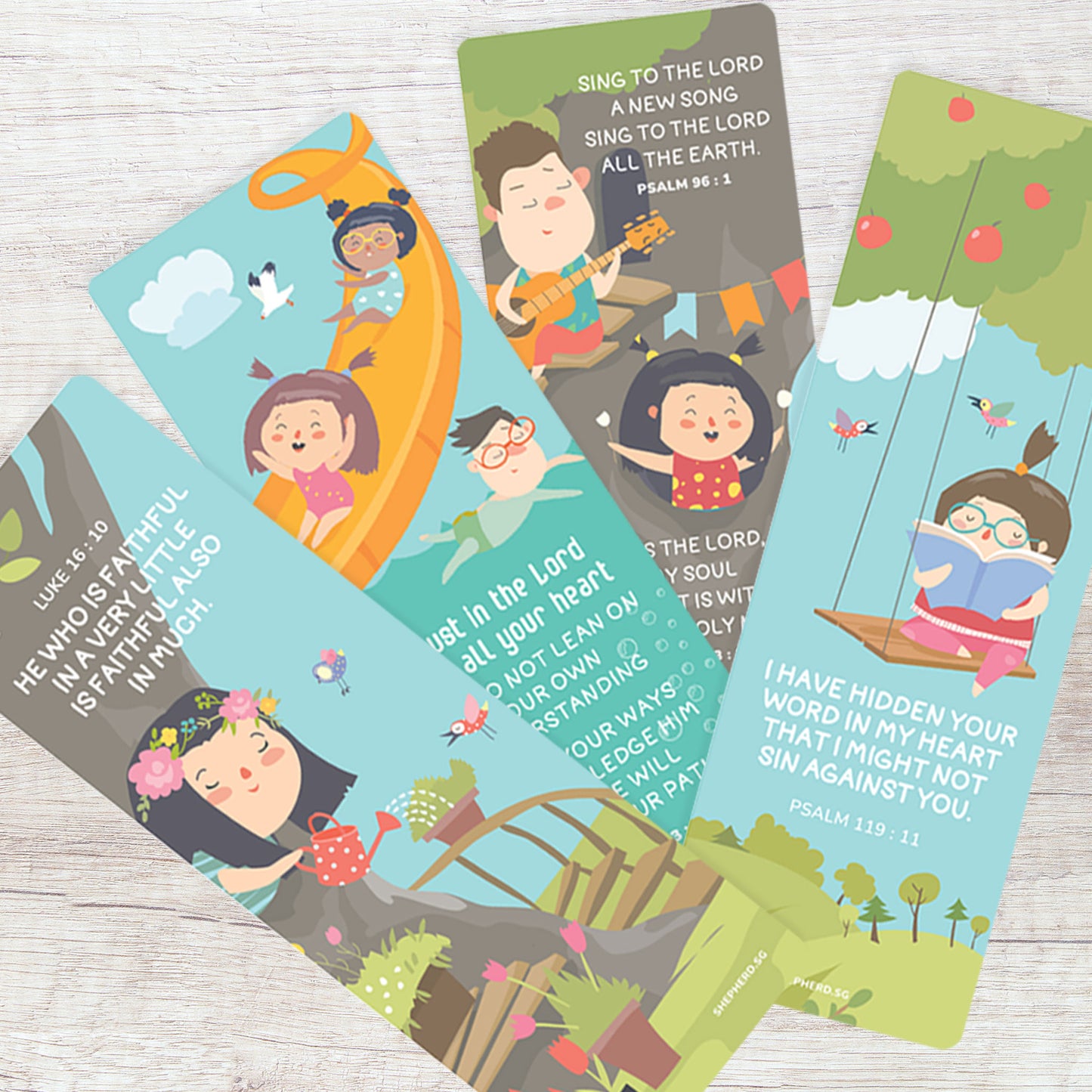Set of colorful children's bookmarks with illustrations and Bible verses on a wooden surface.