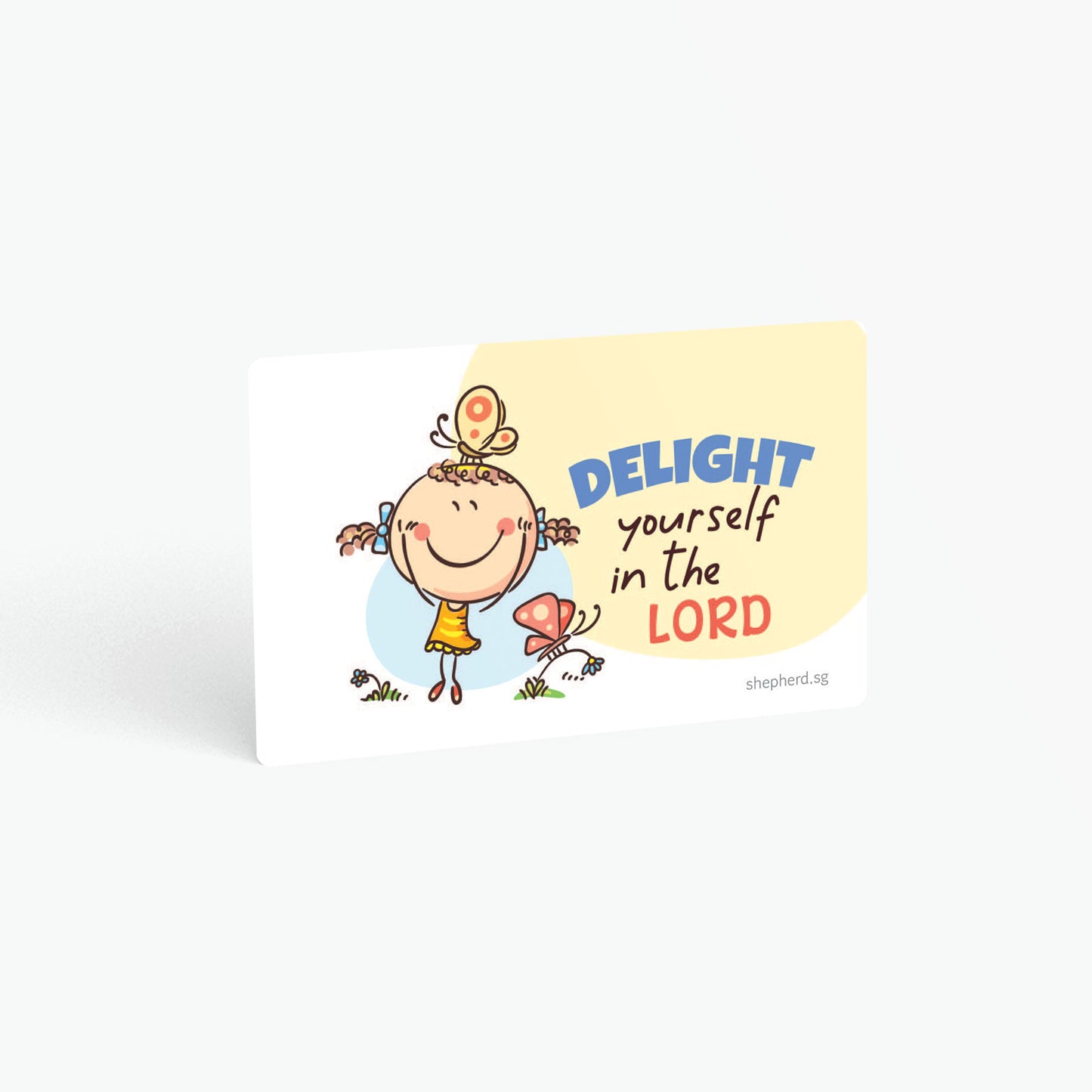 A curved corner wallet card size sticker for children standing in landscape on a white background with text "Delight yourself in the Lord"
