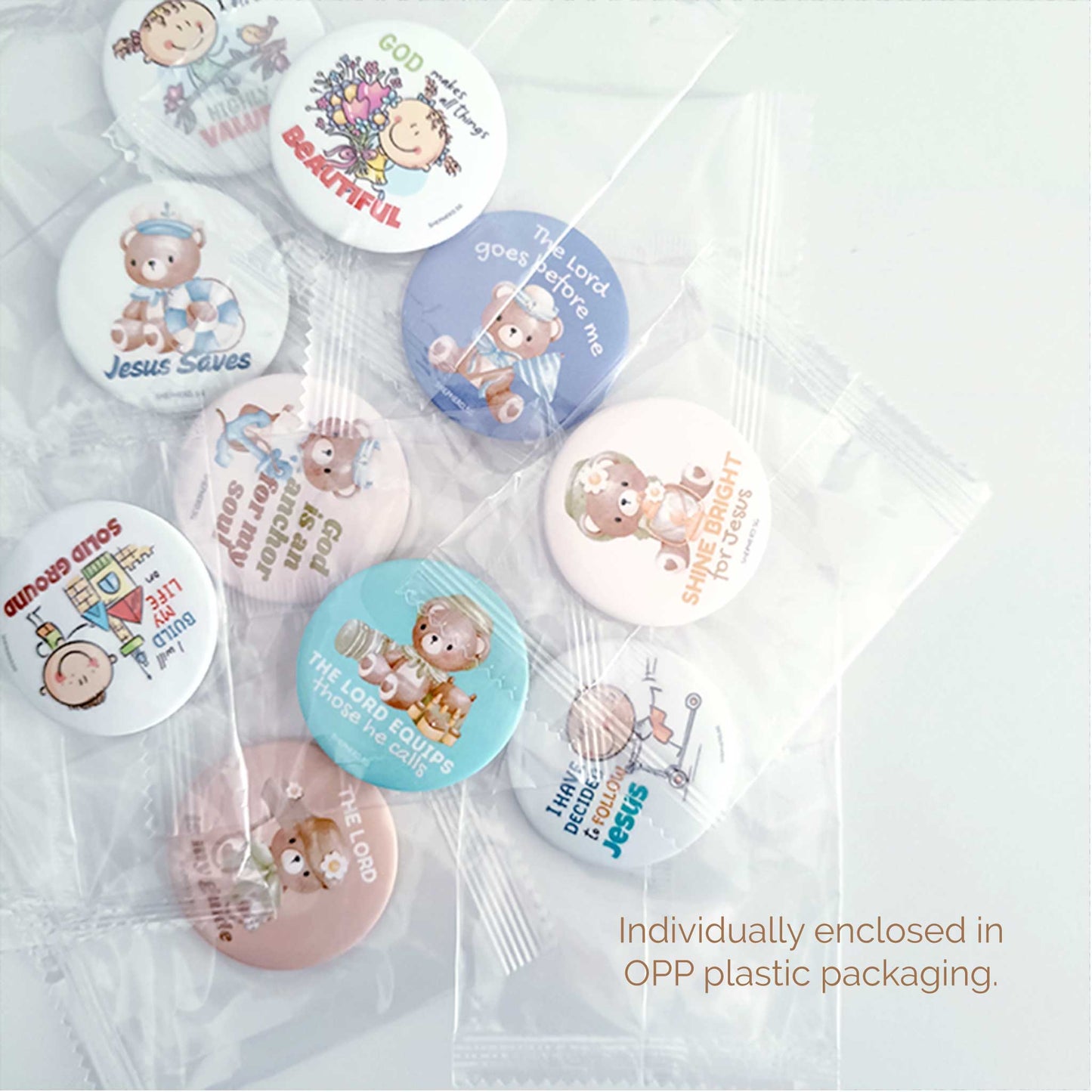 Set of small round pin badges with various designs and Biblical text, individually enclosed in OPP plastic packaging.
