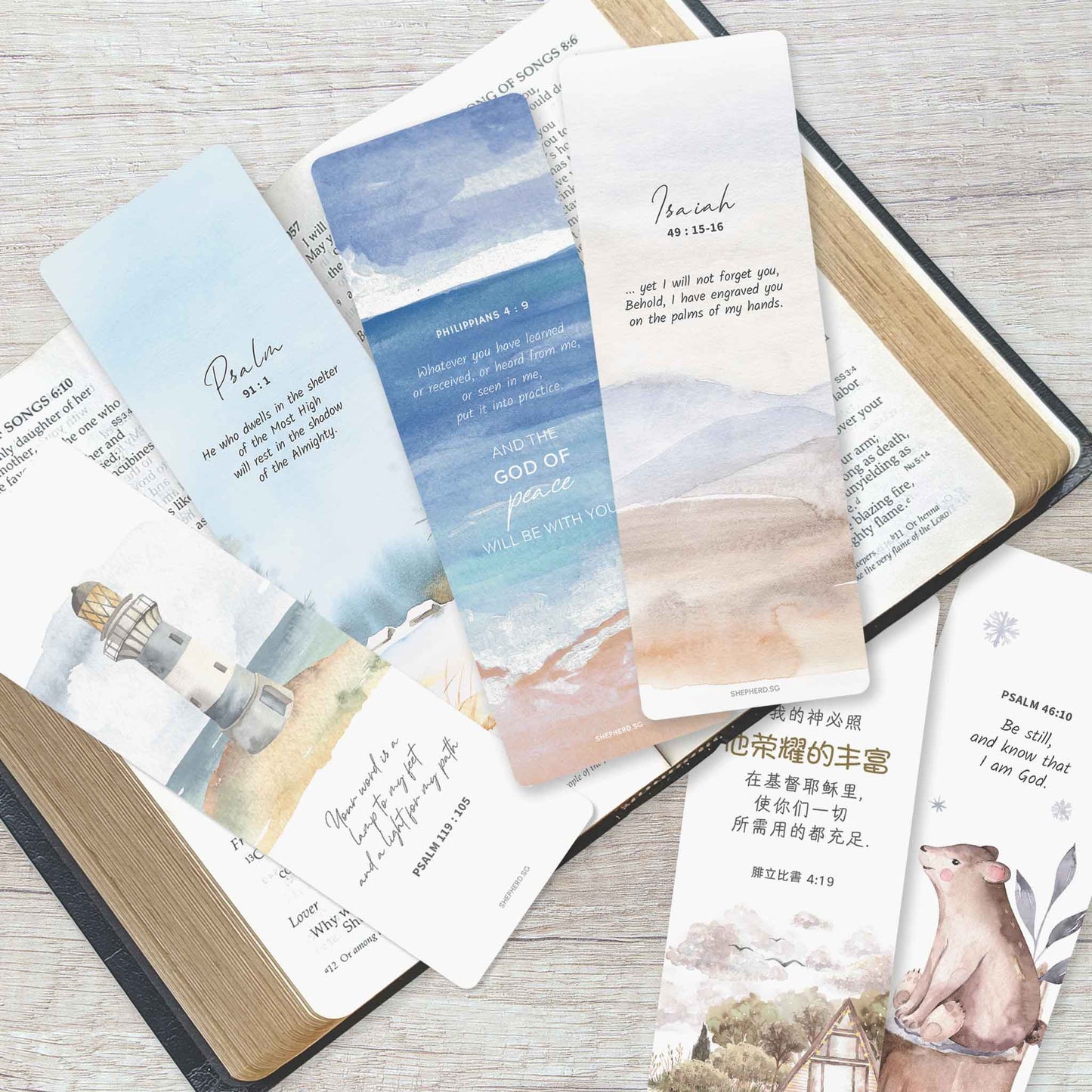 set of scenic bookmarks with bible verses on a bible and wooden surface