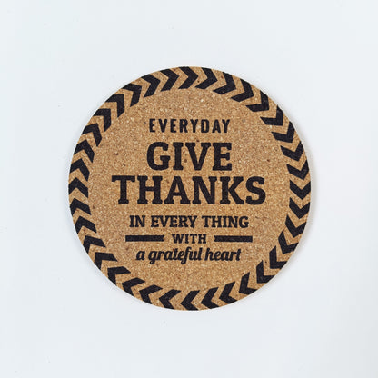 Circle cork coaster with Bible message Give thanks in every thing  on a white background