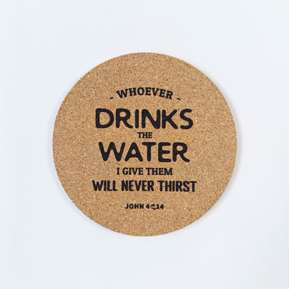 Circle cork coaster with Bible verse John 4:14 on a white background