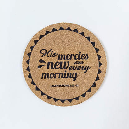 Circle cork coaster with Bible verse Lamentations 3 His mercies are new every morning on a white background
