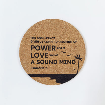 Circle cork coaster with Bible verse 2 Timothy 1:7 and beach silhouette design on a white background