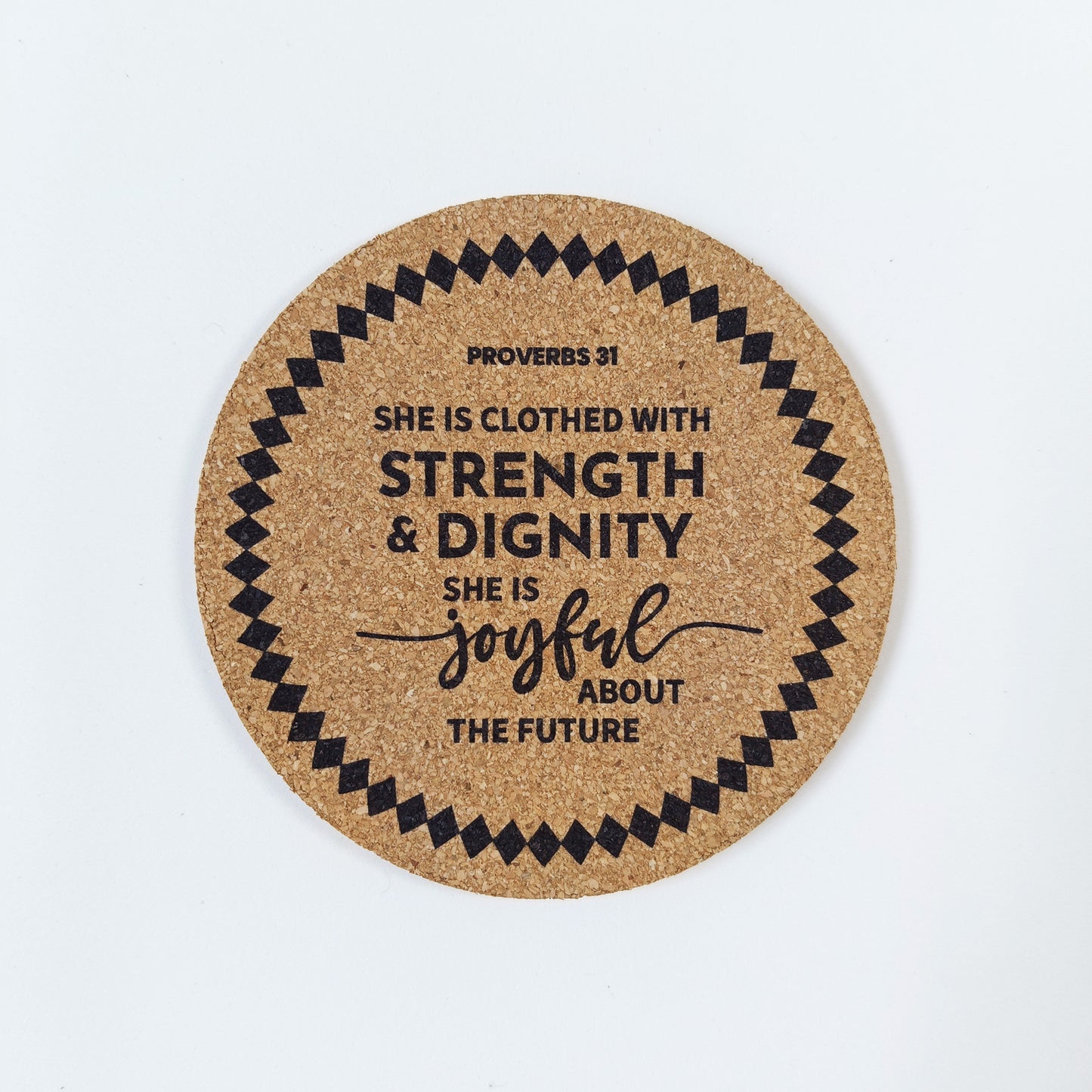 Circle cork coaster with Bible verse Proverbs 31 she is clothed with strength and dignity on a white background