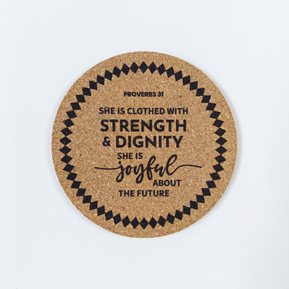 Circle cork coaster with Bible verse Proverbs 31 she is clothed with strength and dignity on a white background