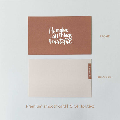 Smooth art card with silver foil text 'He makes all things beautiful' on a white background, shown from front and reverse sides.