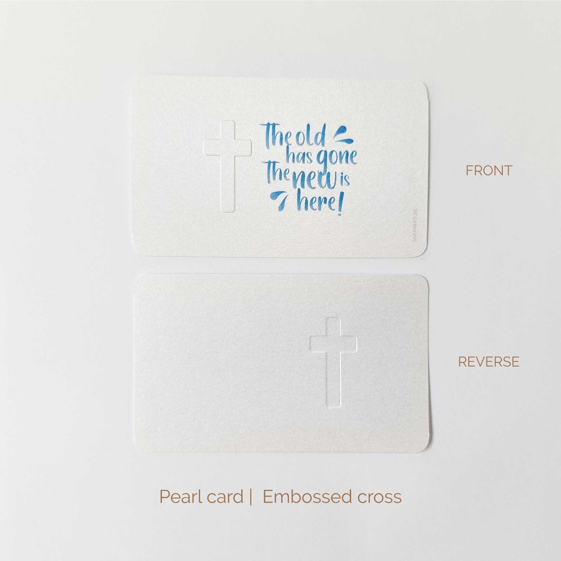 Pearl card with an embossed cross and blue text 'The old has gone the new is here' on a white background, shown from front and reverse sides.