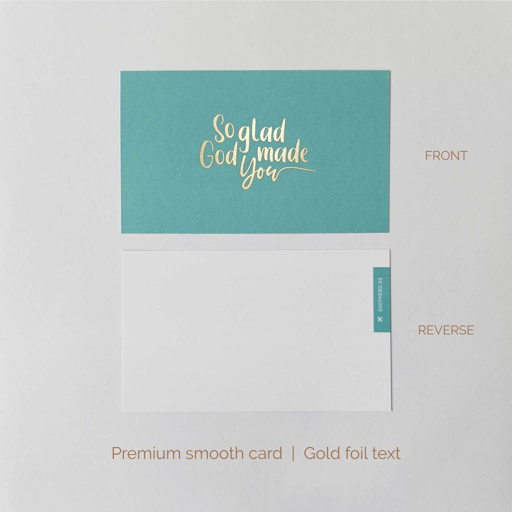 Smooth art card with gold foil text 'So glad God made you' on a white background, shown from front and reverse sides.