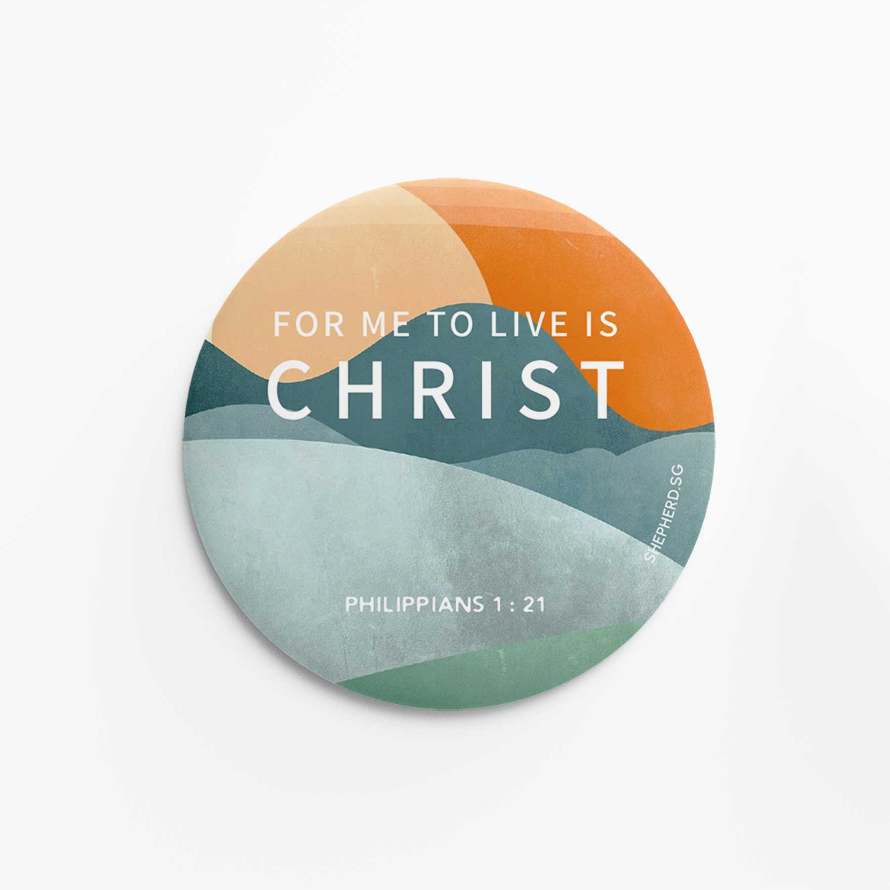 Round pin badge with 'For me to live is Christ' text and color gradient on a white background