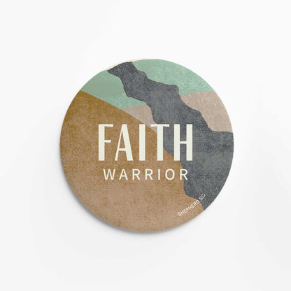 Round pin badge with 'Faith Warrior' text on a multicolored earthy abstract background