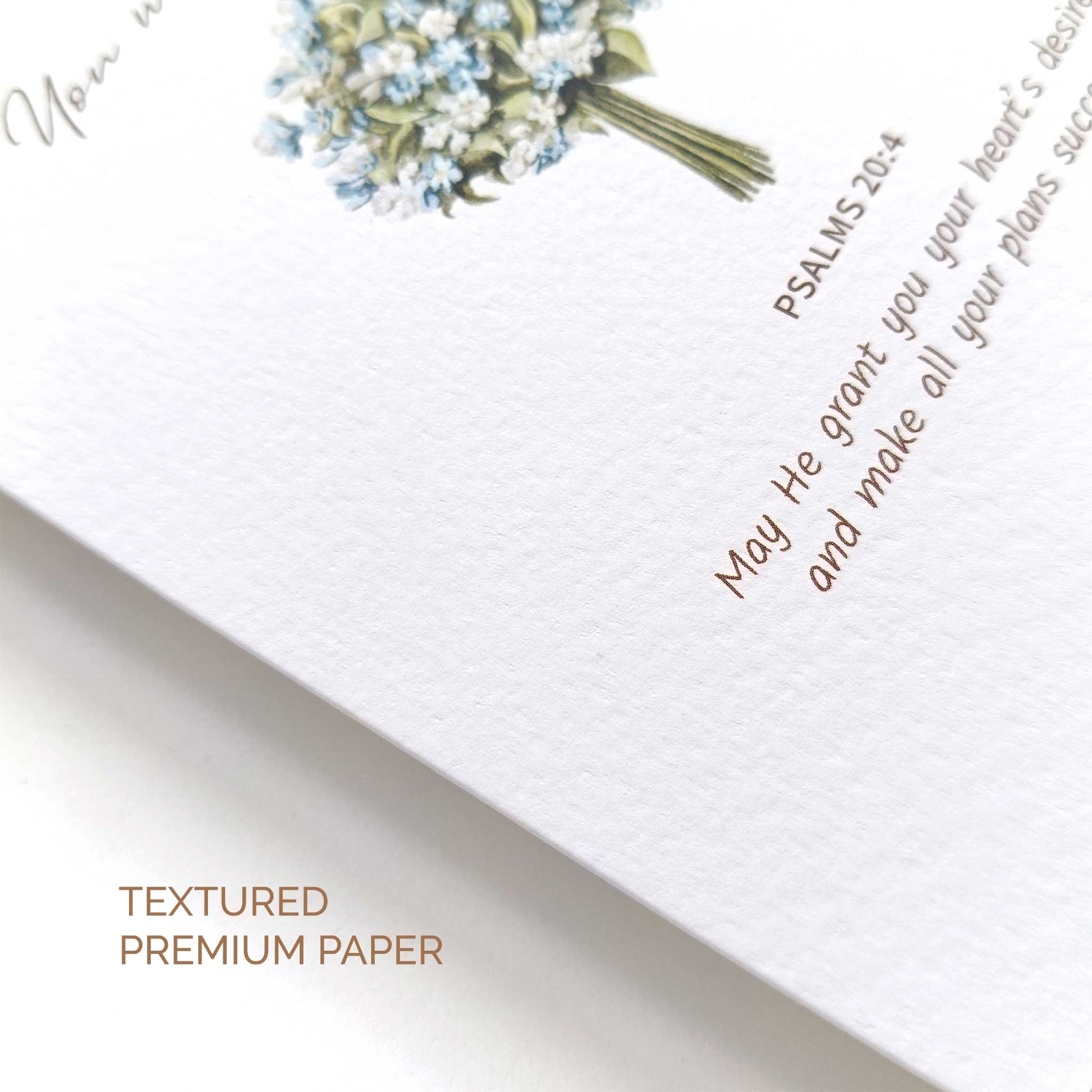 Textured premium paper with floral design and bible verse on a white background