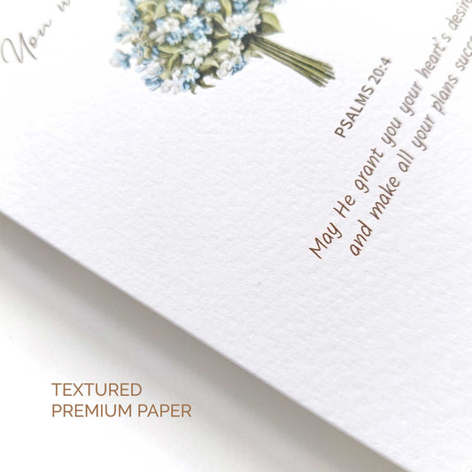 Textured premium paper with floral design and bible verse on a white background