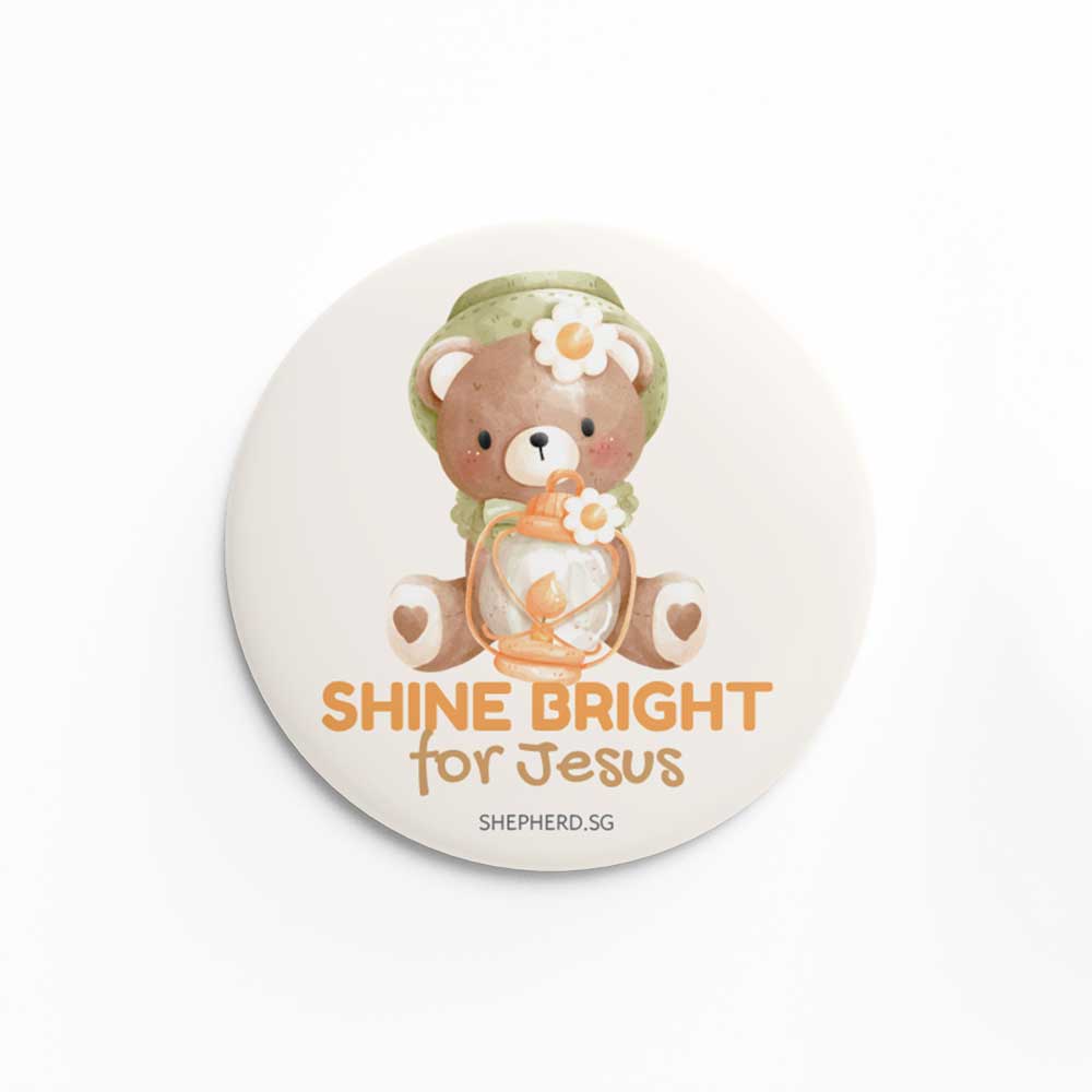 Button pin badge with teddy bear design and 'Shine Bright for Jesus' text on a white background