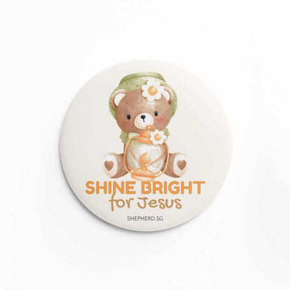 Button pin badge with teddy bear design and 'Shine Bright for Jesus' text on a white background