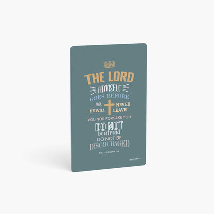 A curved corner wallet card size sticker standing vertically on a white background with Bible verse Deuteronomy 31:8 The Lord Himself goes before you
