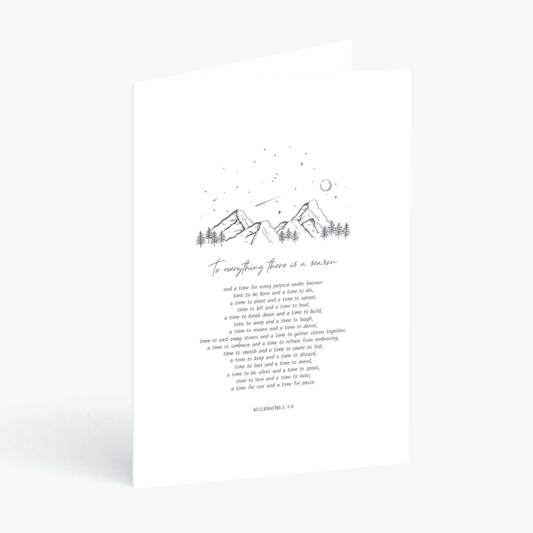A white greeting card with a minimalist black line drawing of mountains, stars, and a moon, above a handwritten quote and the Bible verse 2 Corinthians 4:16. The card is shown standing upright against a clean white background.