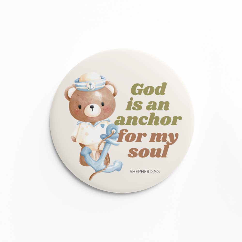 Button pin badge with sailor teddy bear design and 'God is an anchor for my soul' text on a white background