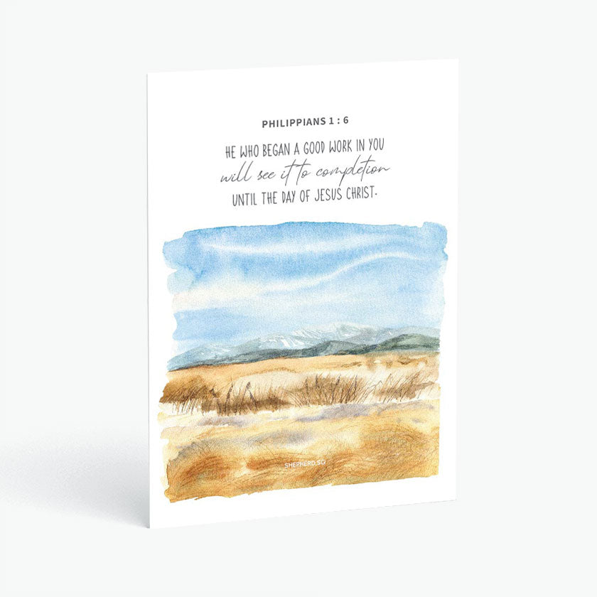 Christian postcard with Bible verse Philippians 1:6 and watercolor design of mountains in the horizon, blue skies and brown fields on white background