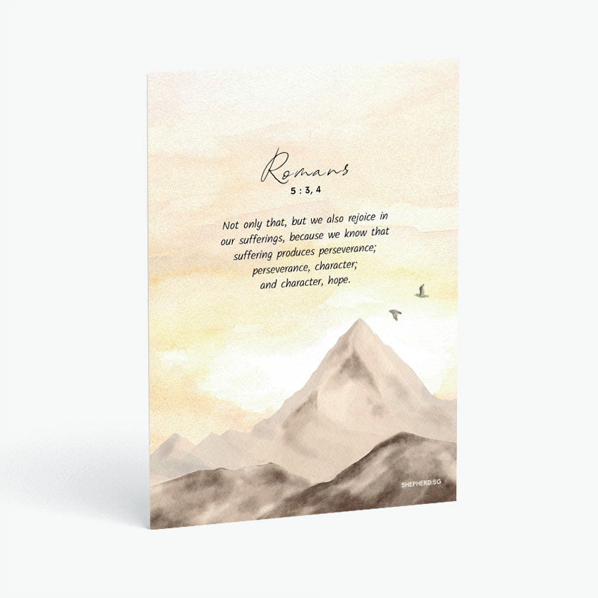 Christian postcard with Bible verse Romans 5:3 and watercolor design of sunset and mountain top 
