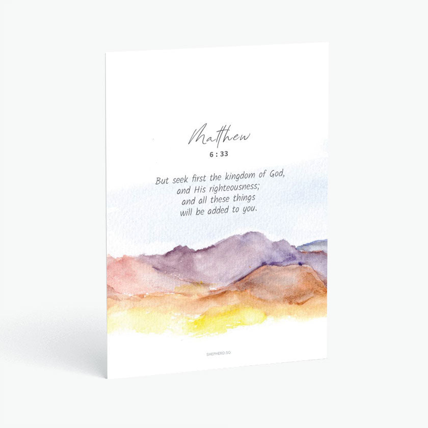 Christian postcard with Bible verse Matthew 6:33 and watercolor sunset on mountain range on white background