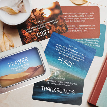 Christian prayer cards designed by shepherd.sg and tin box packaging flat lay on a table with leaves